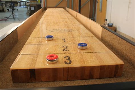 The furthest puck gets the points for the round. Buying A Shuffleboard Table For DummiesMcClure Tables