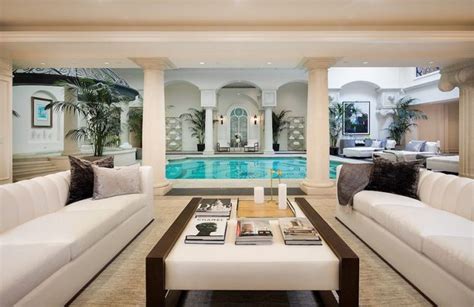 A Living Room Filled With Furniture Next To A Swimming Pool