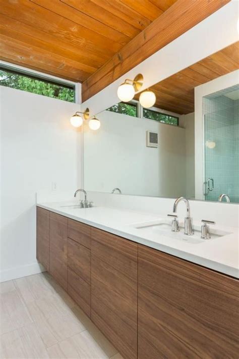 This luxurious bathroom remodel features dark grey walls, free standing tub and pedestal sink, grey porcelain tile floor, mid century style vanity lights and white trim for a spacious, elegant look. Beautiful MID Century Bathroom Remodel Ideas | Mid century ...