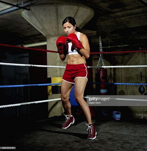 Stock Photo Young Female Boxer In Ring Gloves Raised Portrait