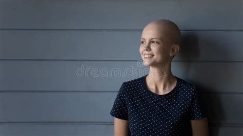 Smiling Woman Cancer Patient Standing Near Grey Wall Expressing Courage