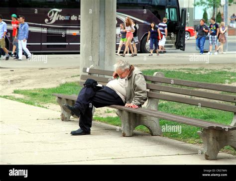 A Man Is Sleeping On A Bench In Toronto Stock Photo Alamy