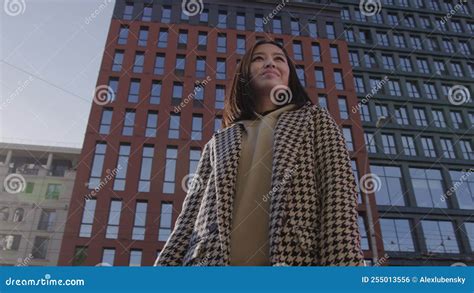 Low Angle Shot Of An Asian Woman In Downtown Camera Pivoting Around