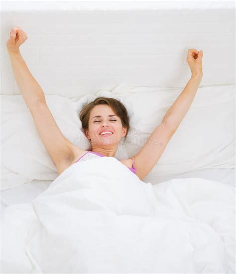 Young Woman Waking Up And Stretching Stock Photo Image Of Copyspace