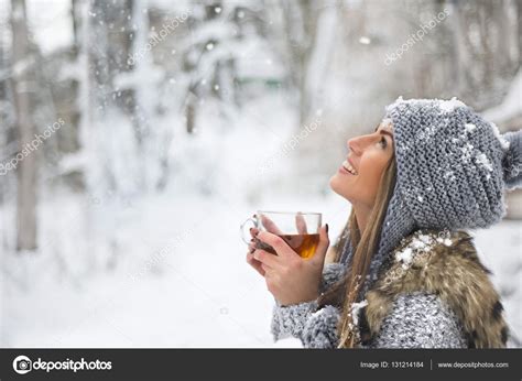 Girl Enjoys The Snow Falls Young Woman In A Knitted Shape Is Drinking