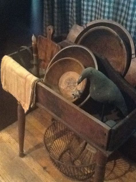 Each of our wooden hand carved dough bowls are completely unique. Old Table...prim crow, rusty wire basket, wooden dough ...