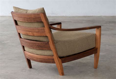 Fully upholstered lounge chair with low back and wood base. Low lounge chair by Matthew Hilton | STYLEPARK