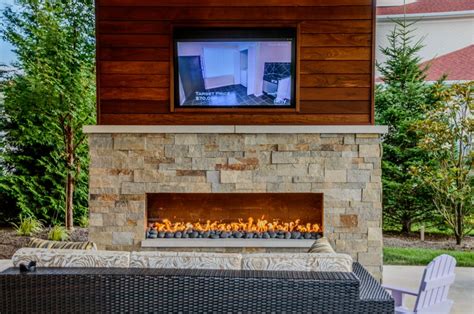Outdoor Living Space With Covered Patio And Fireplace In