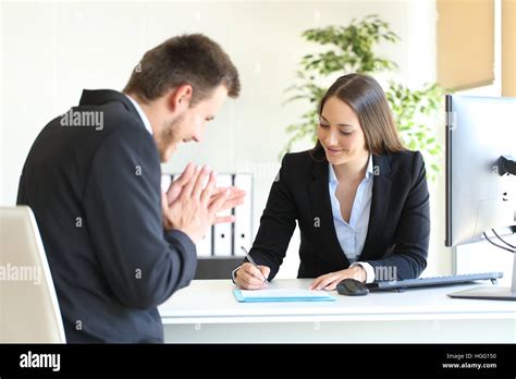 Businesspeople Wearing Suit Signing Contract After A Successful Deal At