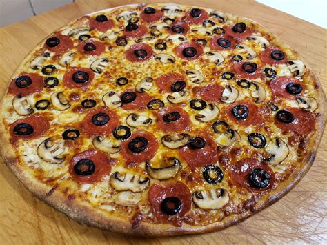 Home Made Pepperoni Mushroom Black Olive And Garlic Thin Crust Pie Pizza