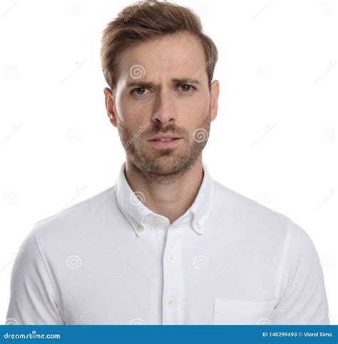 Confused Business Man Standing Against Grey Background With White