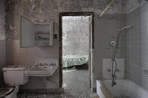 Bathroom And Look Into A Patient Bedroom On An Abandoned Psychiatric