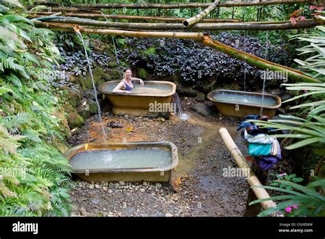 a woman relaxes in a hot volcanic sulphur spring bathtub at ti kwen glo cho near wotten waven in