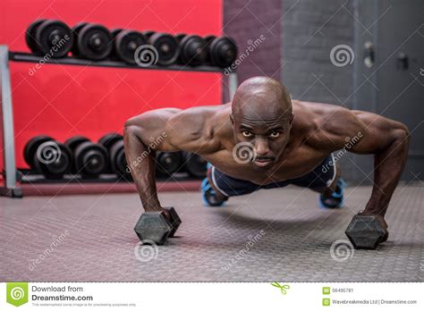 Portrait Of Muscular Man Doing Push Ups With Dumbbells Stock Image