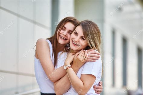 Premium Photo Adult Daughter Hugs Mom And Both Are Smiling At The Camera