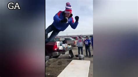Terrifying Moment Buffalo Bills Fan Nearly Breaks Neck In Reckless Jump Onto Table Outside