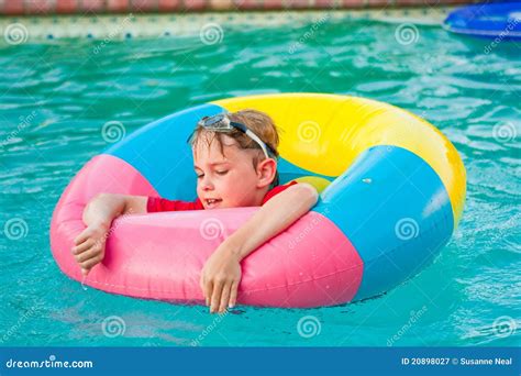Boy In Colorful Float Ring In Swimming Pool Royalty Free Stock