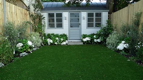 Artificial easy grass lawn summer house sandstone paving and white