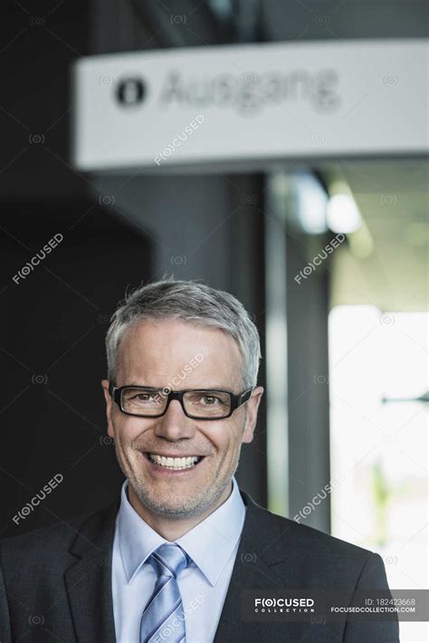 Businessman Standing In Office Building Portrait Smiling — 50 60