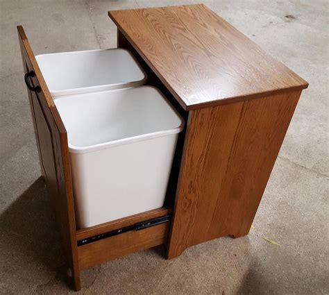 This tilt out trash bin made by nicole is perfect for everyday use. Picture of Amish Wooden Double tilt-out Trash Bin #kitchenfurnitureideascoats | Trash can ...
