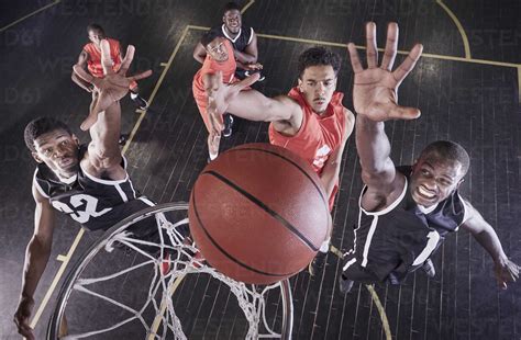 Overhead View Young Male Basketball Players Jumping To Rebound