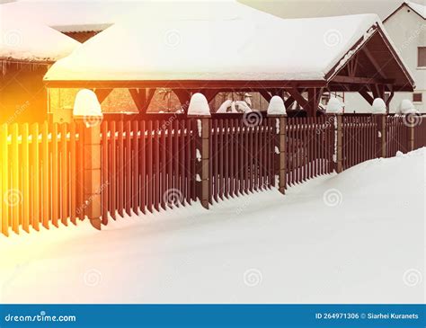 Natural Light Winter A Lot Of Snowdrifts Brown Metal Picket Fence