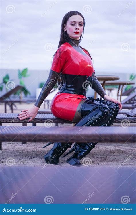 Fashion Stylish Lady Wear Latex Rubber Clothes On The Beach Outdoor
