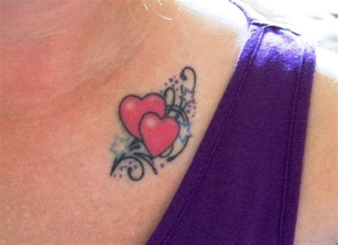 A Woman With A Tattoo On Her Chest Has Two Hearts In The Shape Of A Heart