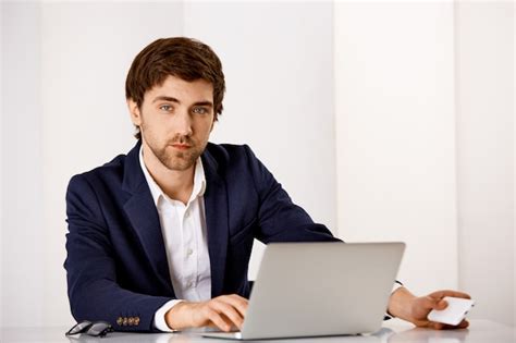 Free Photo Serious Looking Handsome Businessman In Suit Sit Office