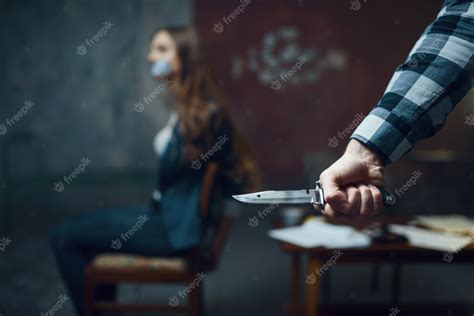 Premium Photo Maniac Kidnapper With A Knife Scared Female Victim On
