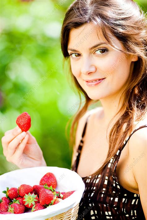 Young Woman Eating Strawberries Stock Image C0313603 Science Photo Library