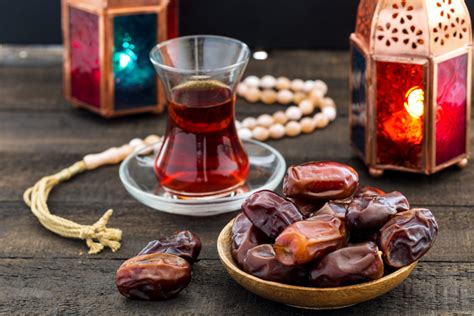 Ramadan Kareem Festive, close up of dates on wooden plate and rosary