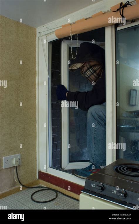 Burglar Breaking Into A House Stock Photo Alamy