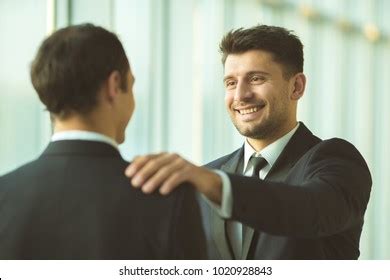 Happy Businessmen Hold On Shoulder Office Shutterstock