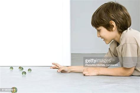 Childhood Boy Play One Marble Photos And Premium High Res Pictures