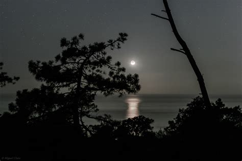 The Moonset Over The Ocean Astrophotography By Miguel Claro