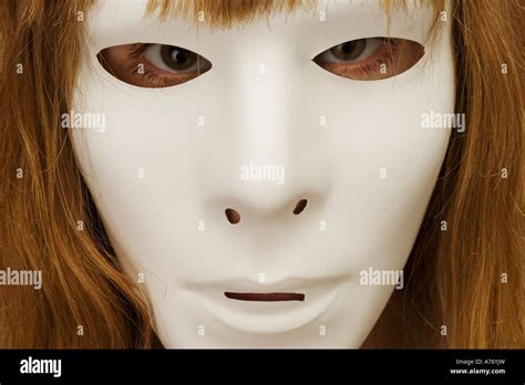 Woman hiding behind mask Stock Photo - Alamy