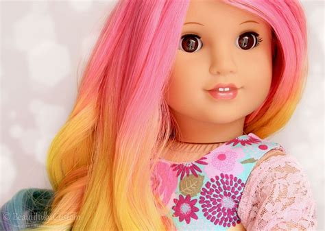 a close up of a doll with pink and yellow hair wearing a flowered dress