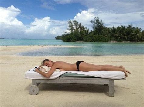 Heidi Klum Shares Topless Sunbathing Shot On Tropical Island
