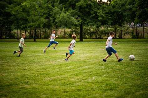 Boys Play Football In The Park Stock Photo Download Image Now Istock