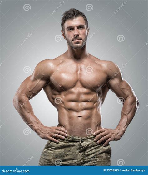 Muscular Athlete Bodybuilder Man On A Gray Background Stock Image Image Of Macho Heavy