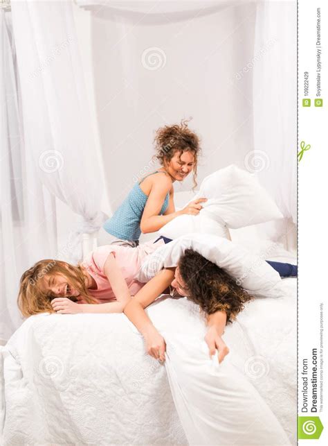 Girls In Bed Having Pillow Fight In Pajamas Stock Image Image Of Smiling Bedroom 109222429
