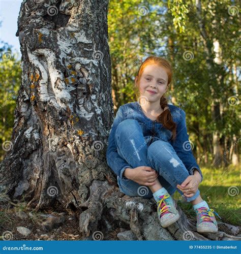 Little Girl Sitting In The Woods Near Birch Nature Stock Image