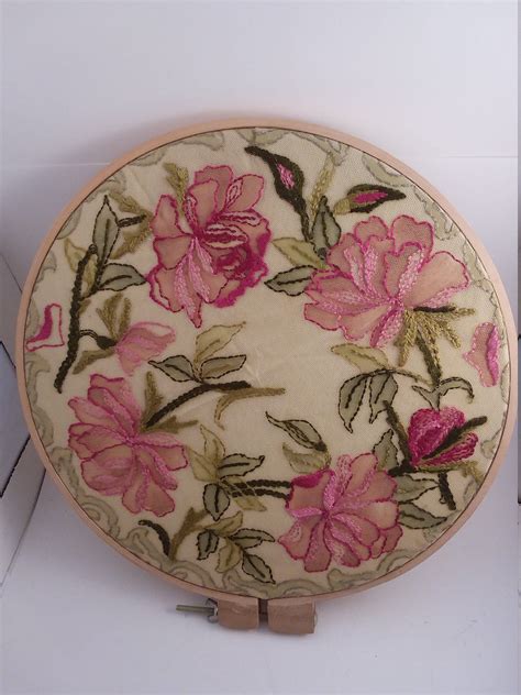 A Pink Flowered Plate Is Sitting On A White Surface