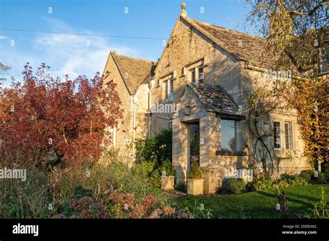 Cotswold Stone House In Autumn Afternoon Sunlight In The Village Of