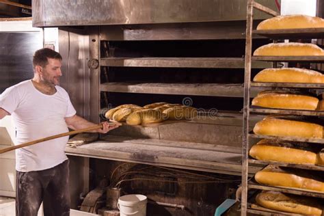 Bakery Worker Taking Out Freshly Baked Breads Stock Image Image Of
