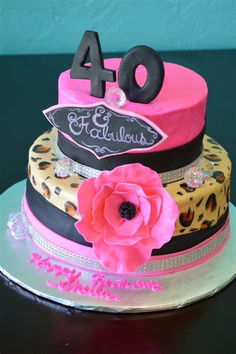 A Birthday Cake Decorated With Leopard Print Pink And Black Flowers