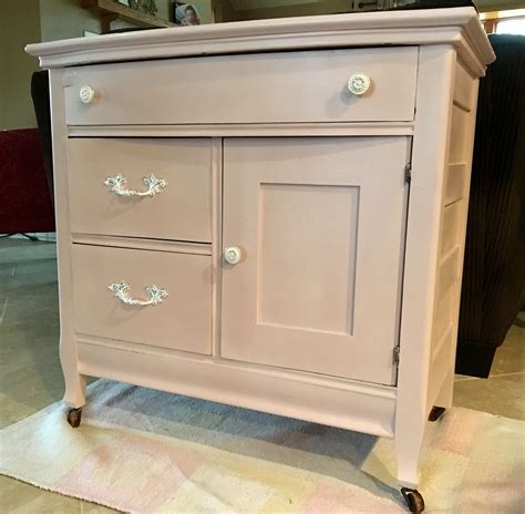 A Pink Dresser Sitting On Top Of A Rug