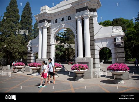 Students Pass By The Old Gate On Campus At Tsinghua University In