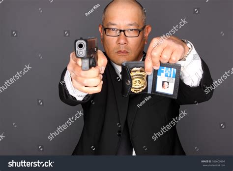 Fbi Agent With Gun And Holding A Badge Stock Photo 103609994